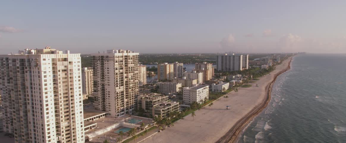 Tall buildings border beach and ocean