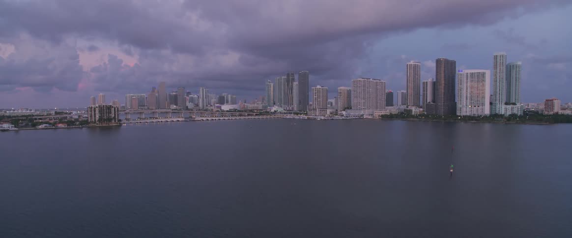 Landscape of small island and city next to ocean on a cloudy day