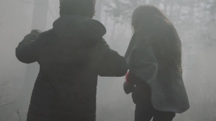 Children running in the fog