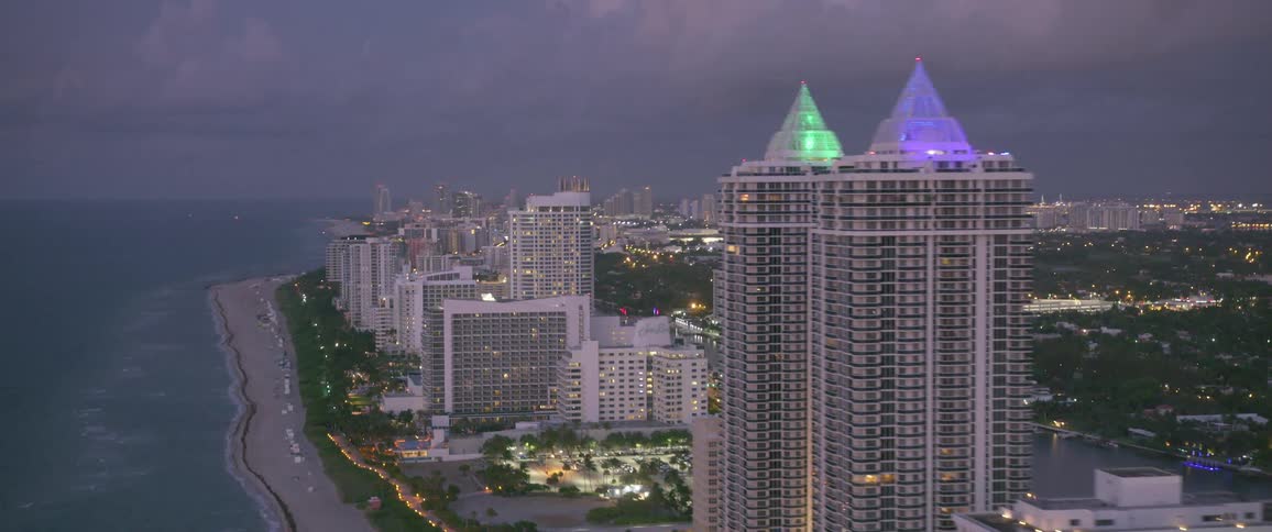A city close to the shore with buildings and skyscrapers