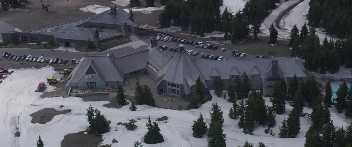 Buildings among snow covered conifers