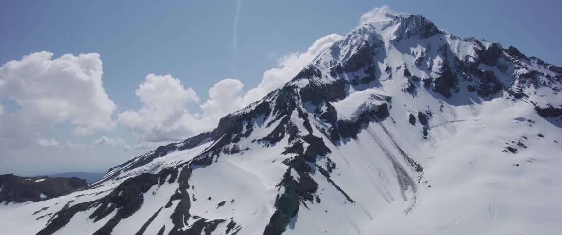 White snow lays on a mountain peak