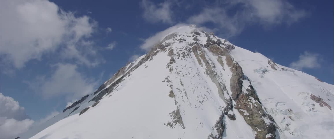 White snow covers a mountain peak during the daytime