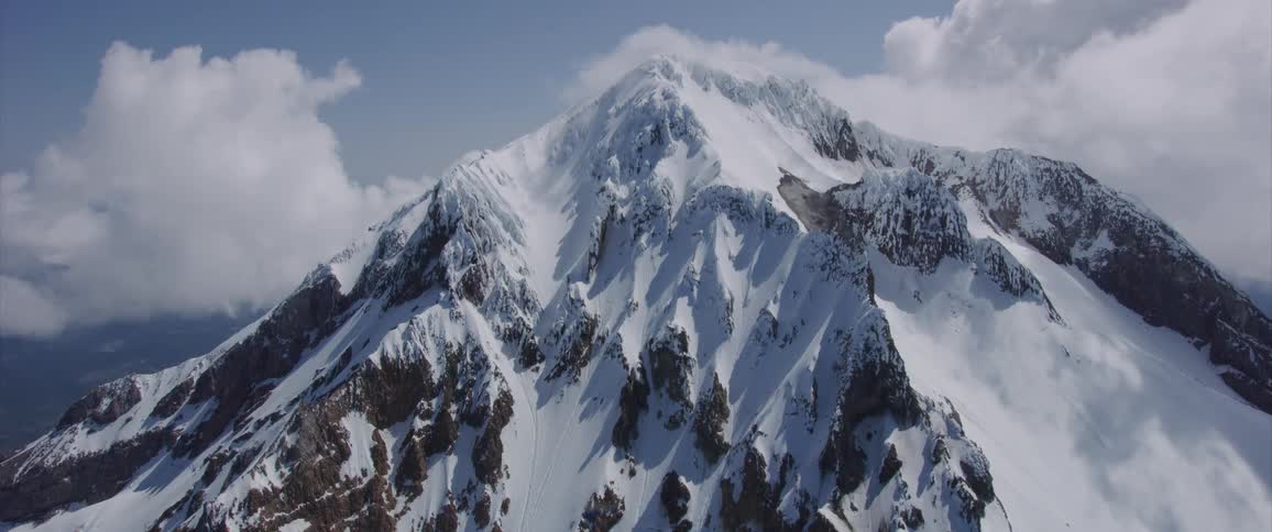 Landscape of snowy mountain with clouds on the sky during daytime