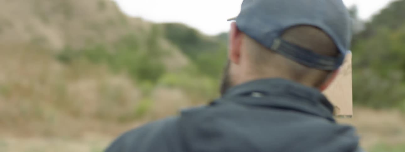 A man looking at a hill for the subject of his painting