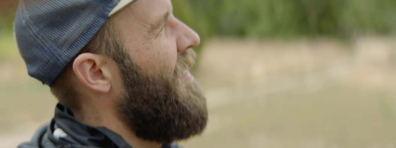 A man stands and looks at the landscape
