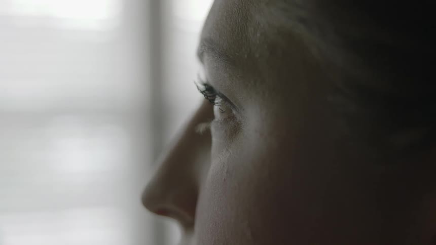A woman opens her eyes abruptly
