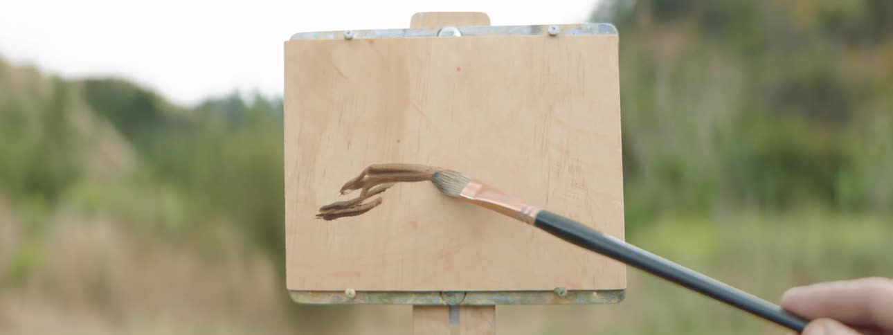 Person paints outdoors