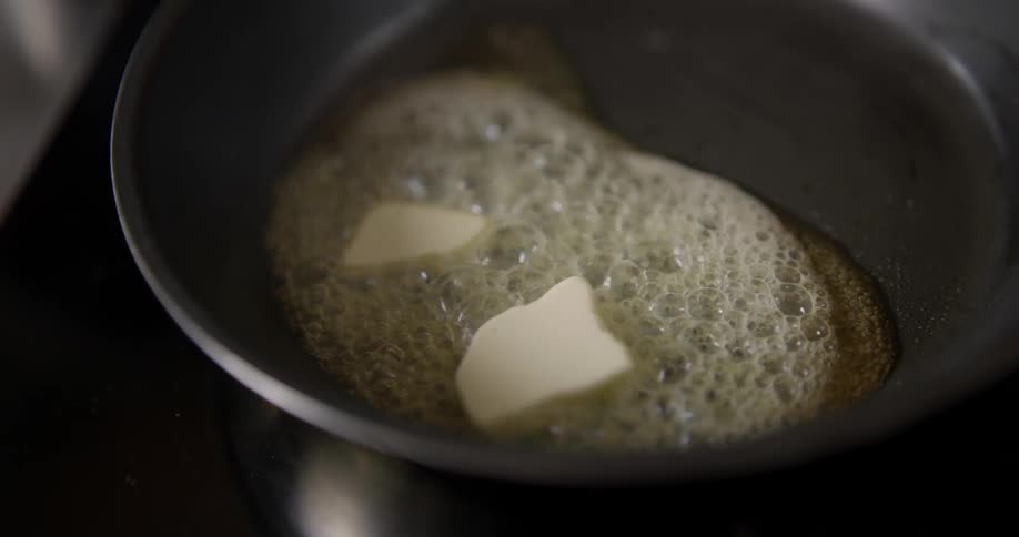 Melting butter in a skillet creates bubbling and boiling.