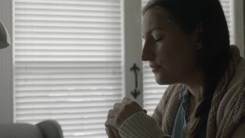 A woman slowly opens her eyes and begins typing in a room