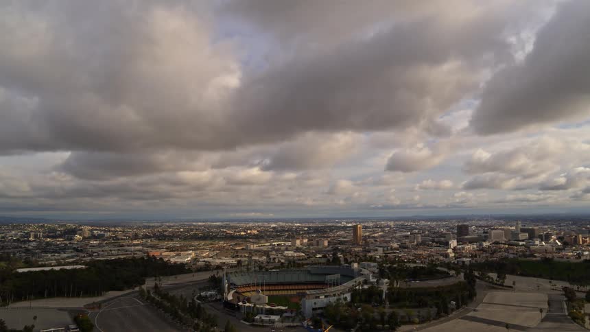 A smooth aerial view of a stadium in a bustling city.