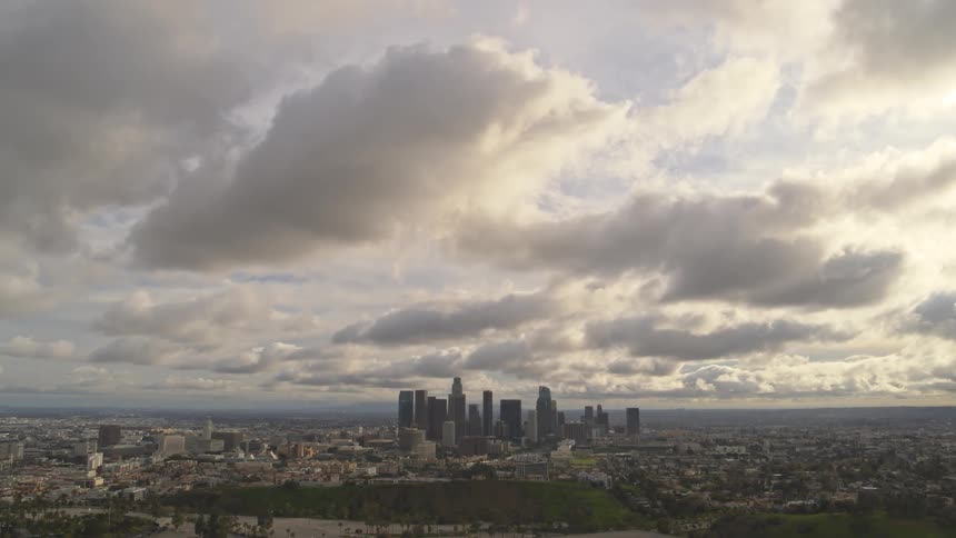 Slow motion aerial view of Los Angeles skyline at dusk.