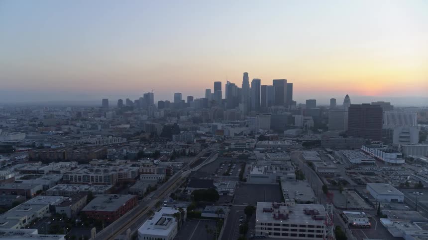 The camera flies over a large metro city