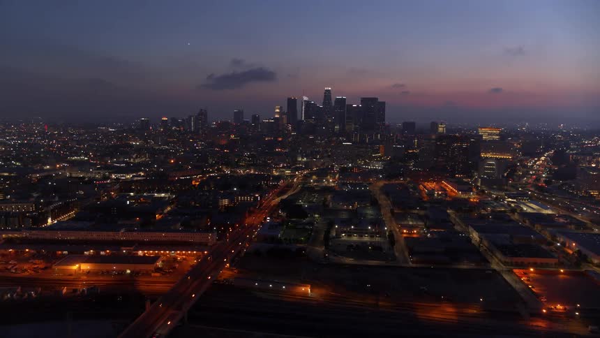 Skyline of the illuminated city with skyscrapers at dusk