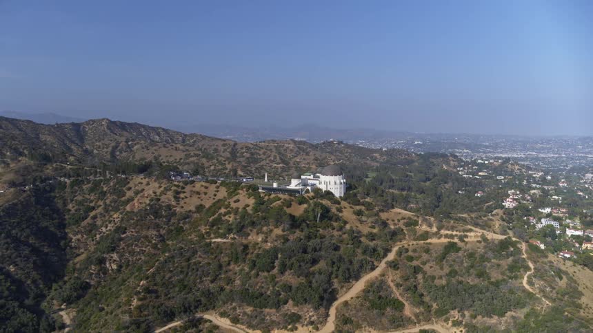 Landscape view of a large building on a hill overlooking a city