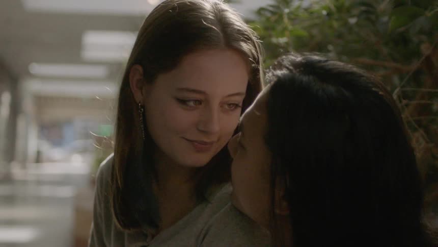 A couple share a happy moment together with a kiss