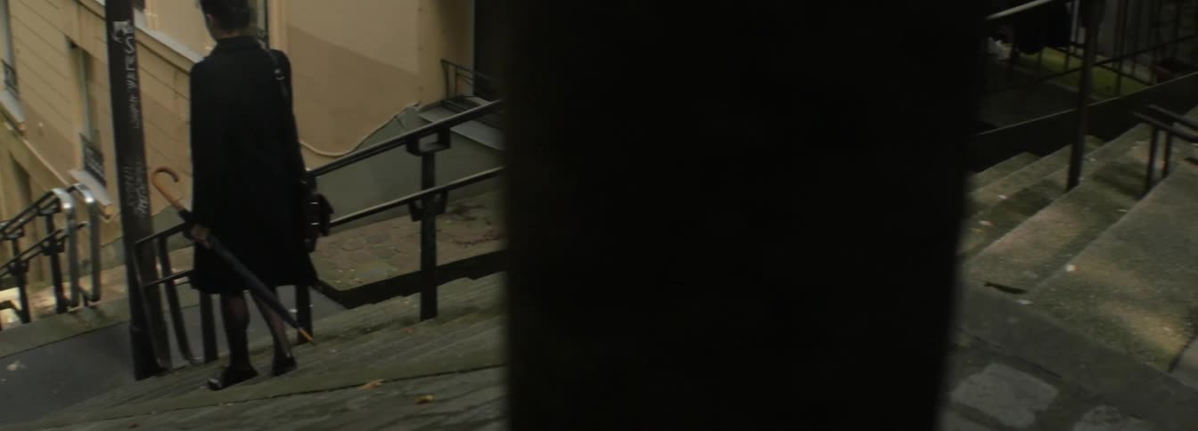 A woman walking down a large set of stairs