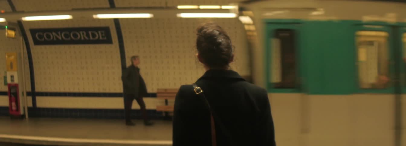 Girl who stands wait for subway train in the underground