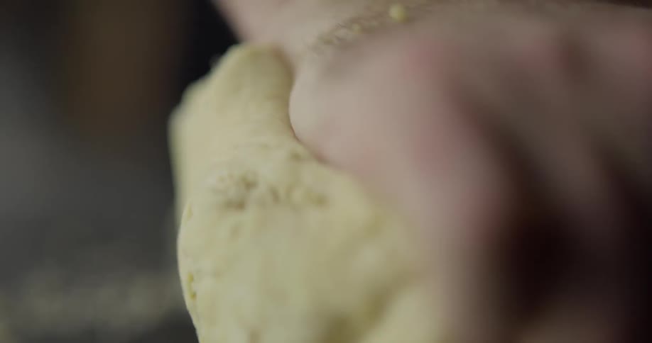 A person kneads a dough