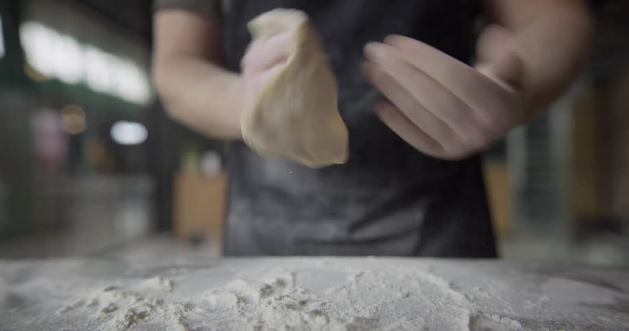 A man kneading dough with his hands