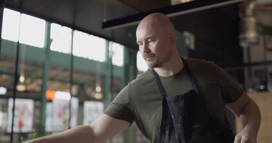 A chef bundles hand made pasta in a professional kitchen