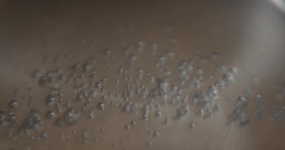 Water beginning to boil in a pan