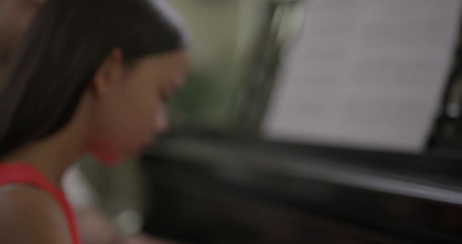A girl plays a piano