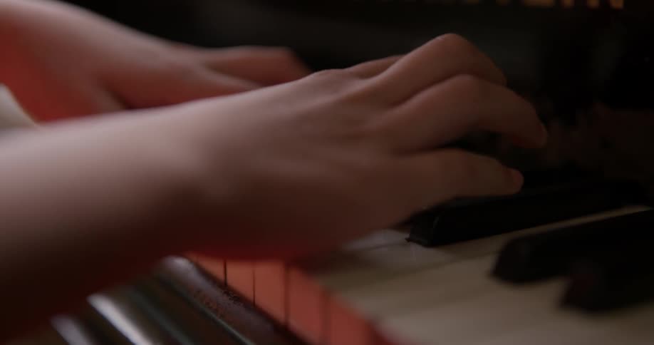 A person pushing piano keys