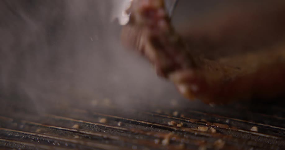 Steak is being cooked on a grill