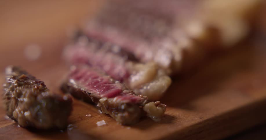 Rare cooked steak pieces on a cutting board
