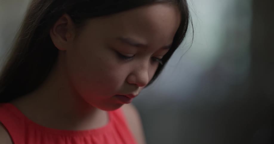 A young girl stares at something off screen