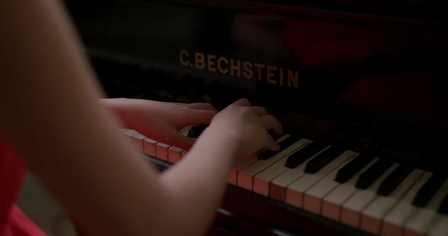 A girl plays the piano
