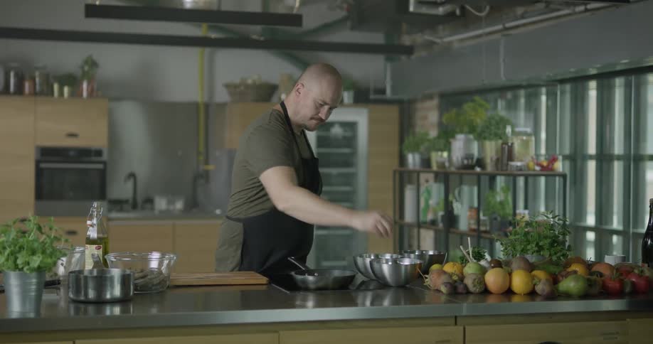 A man is cooking food indoors