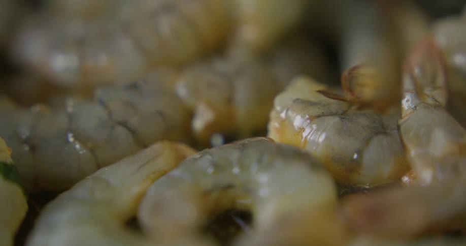 Shrimp is stirred as its being sauteed