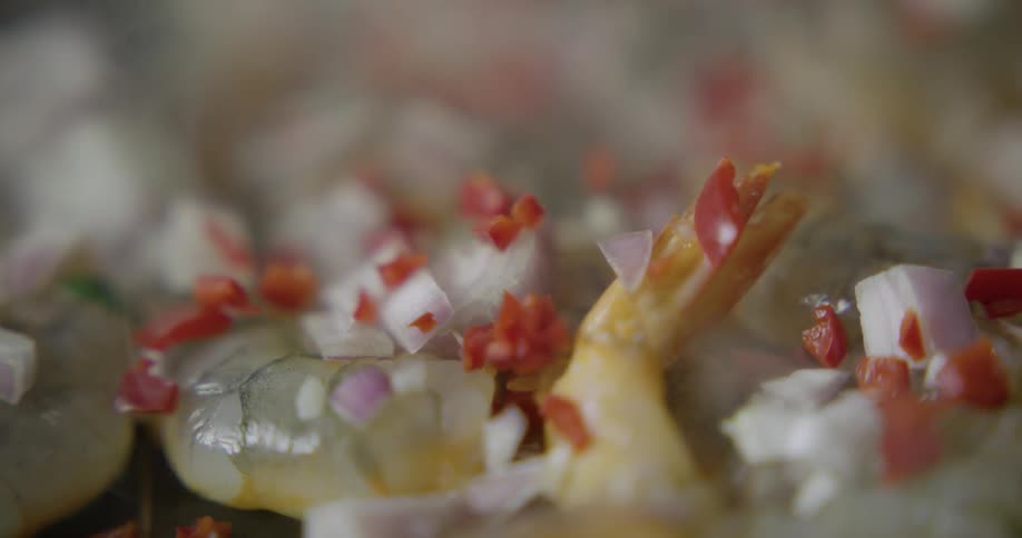 Ingredients are sprinkles onto cooking shrimp
