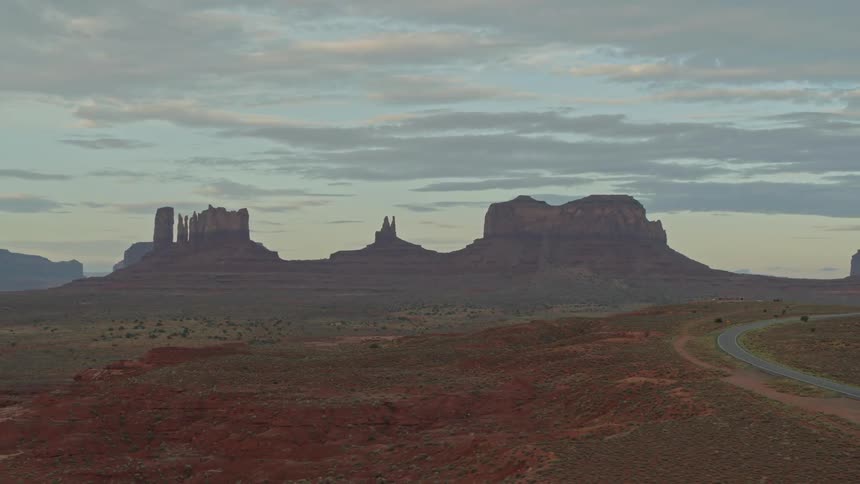 The camera flies across the desert looking at towers