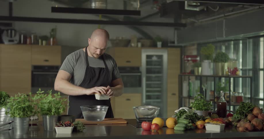 Man dumping vegetables into a bowl of ice water