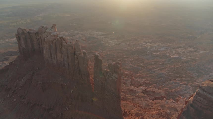 The camera looks down on sandstone desert towers in Utah