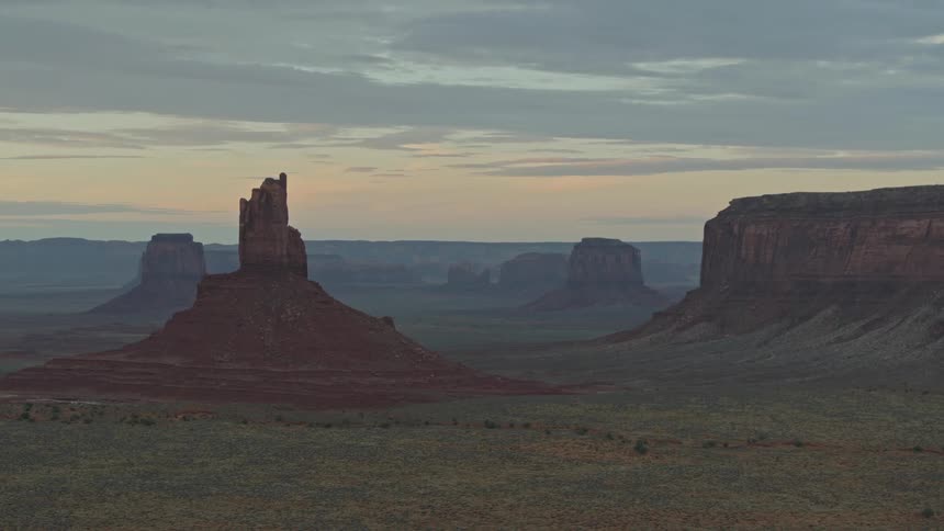 Night falls over the red cliffs of the desert at sunset