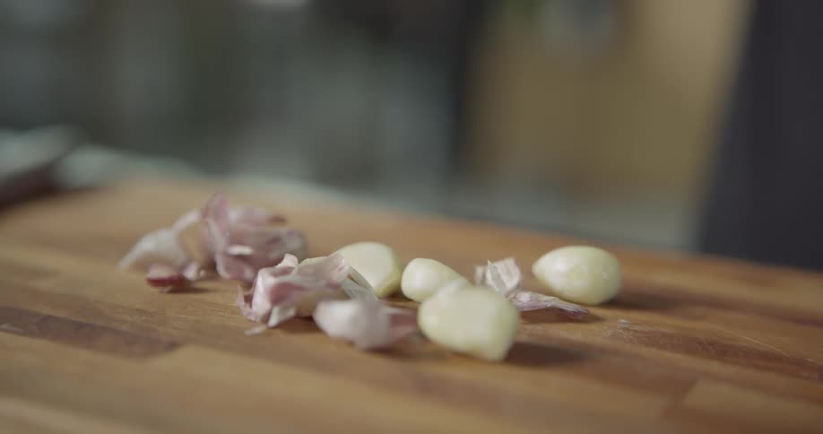 A man dumps garlic out of a jar