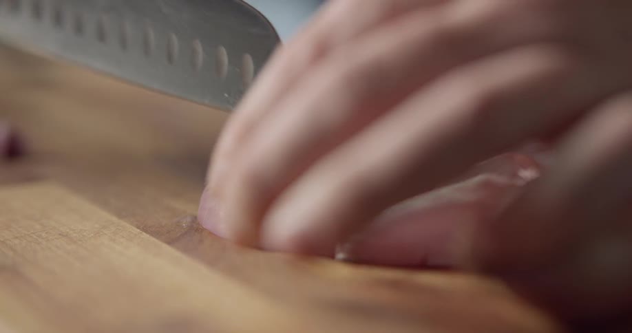 A person is cutting up an onion