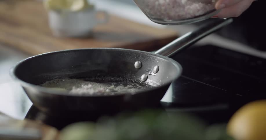 Food being added to a hot pan