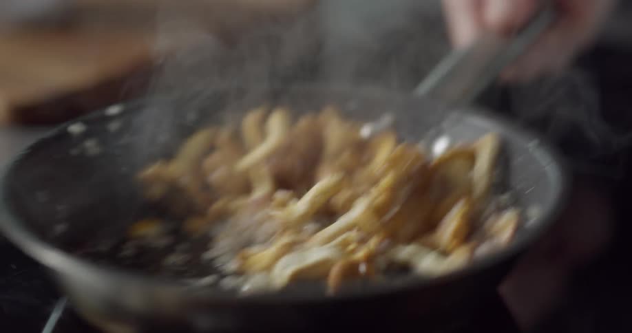 Cauliflower and diced onions being fried in a skillet