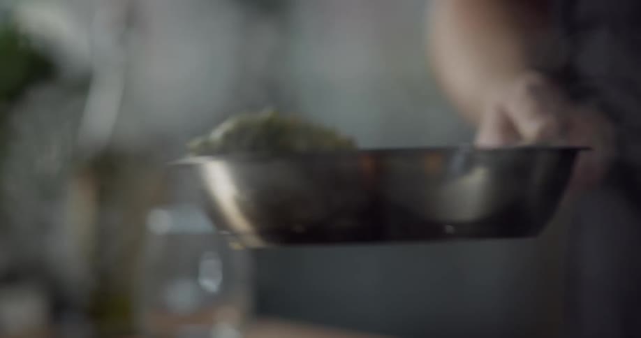 A man turning food on a frying pan