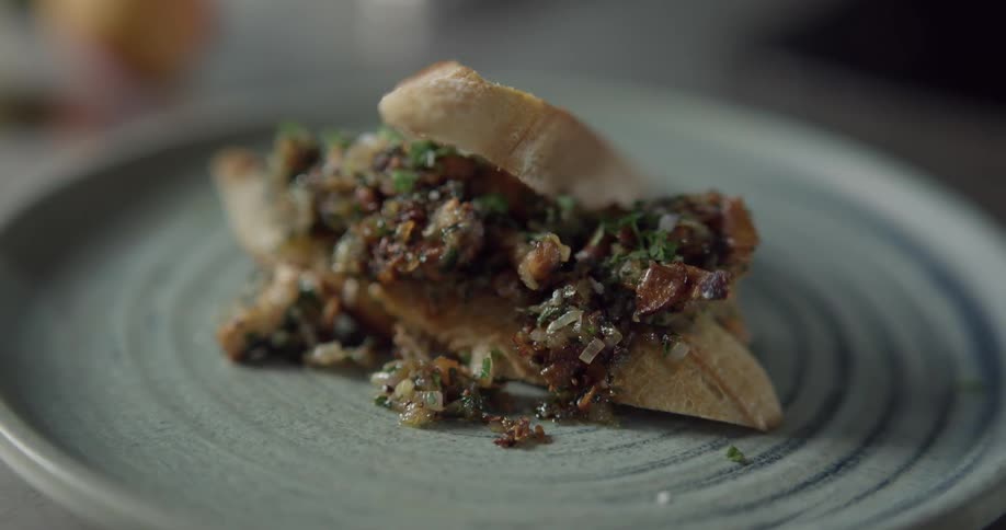 A sandwich of fish and chutney on a plate