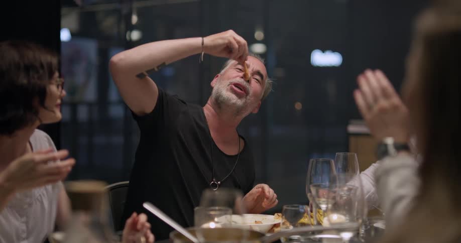 A group of people sit at a table eating