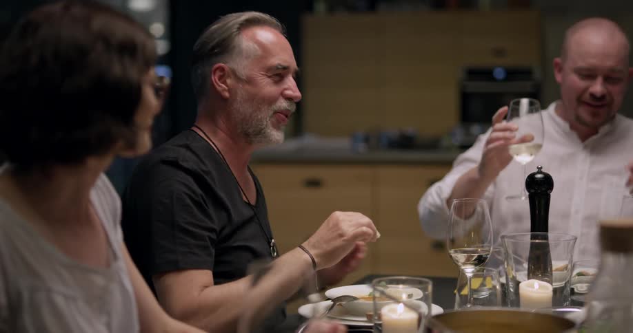 A group sits at a table eating and drinking