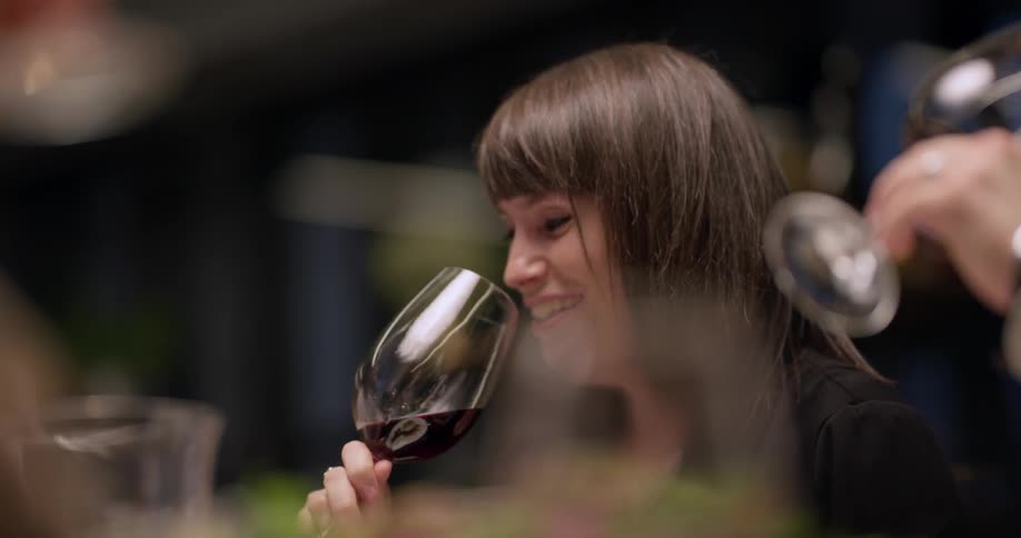 People drinking from wine glasses
