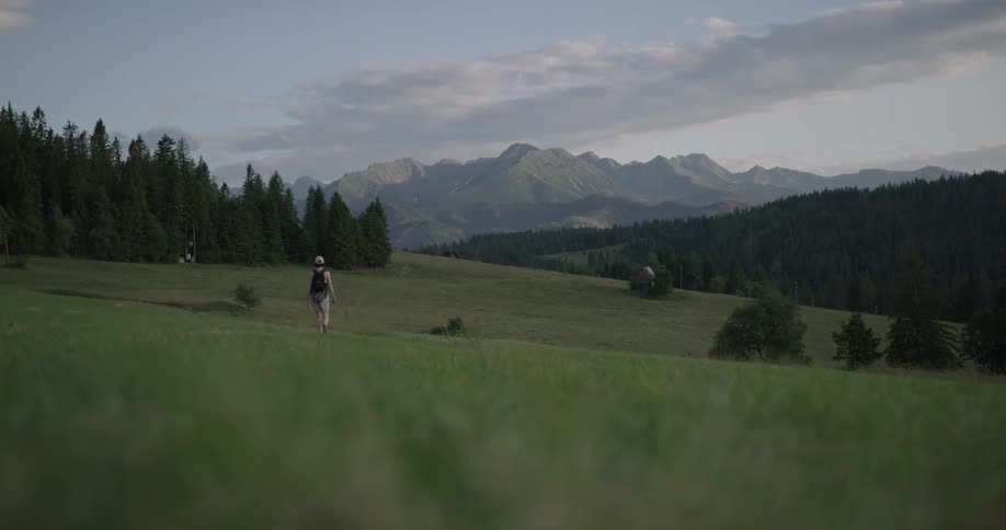 A woman walks across a field