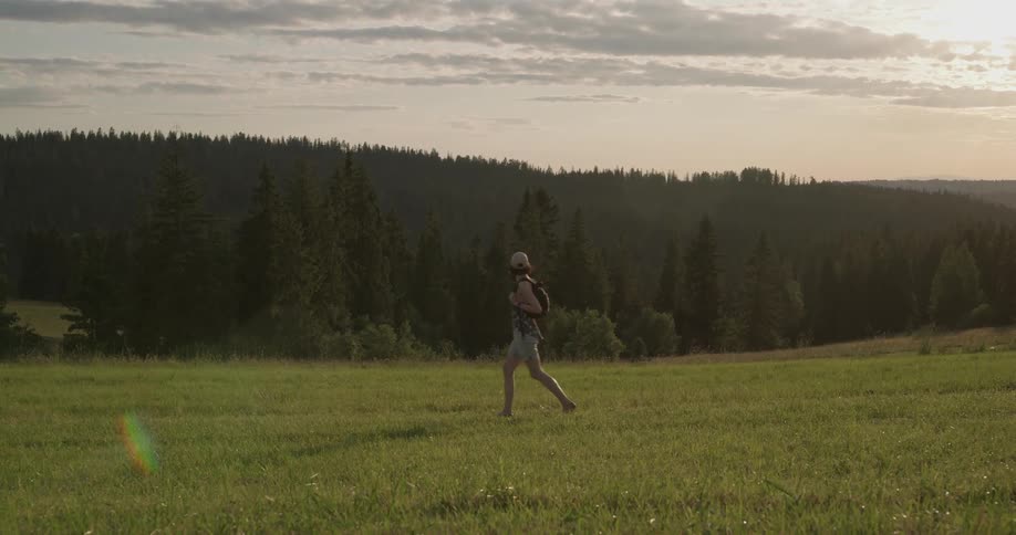 A woman walks through a field